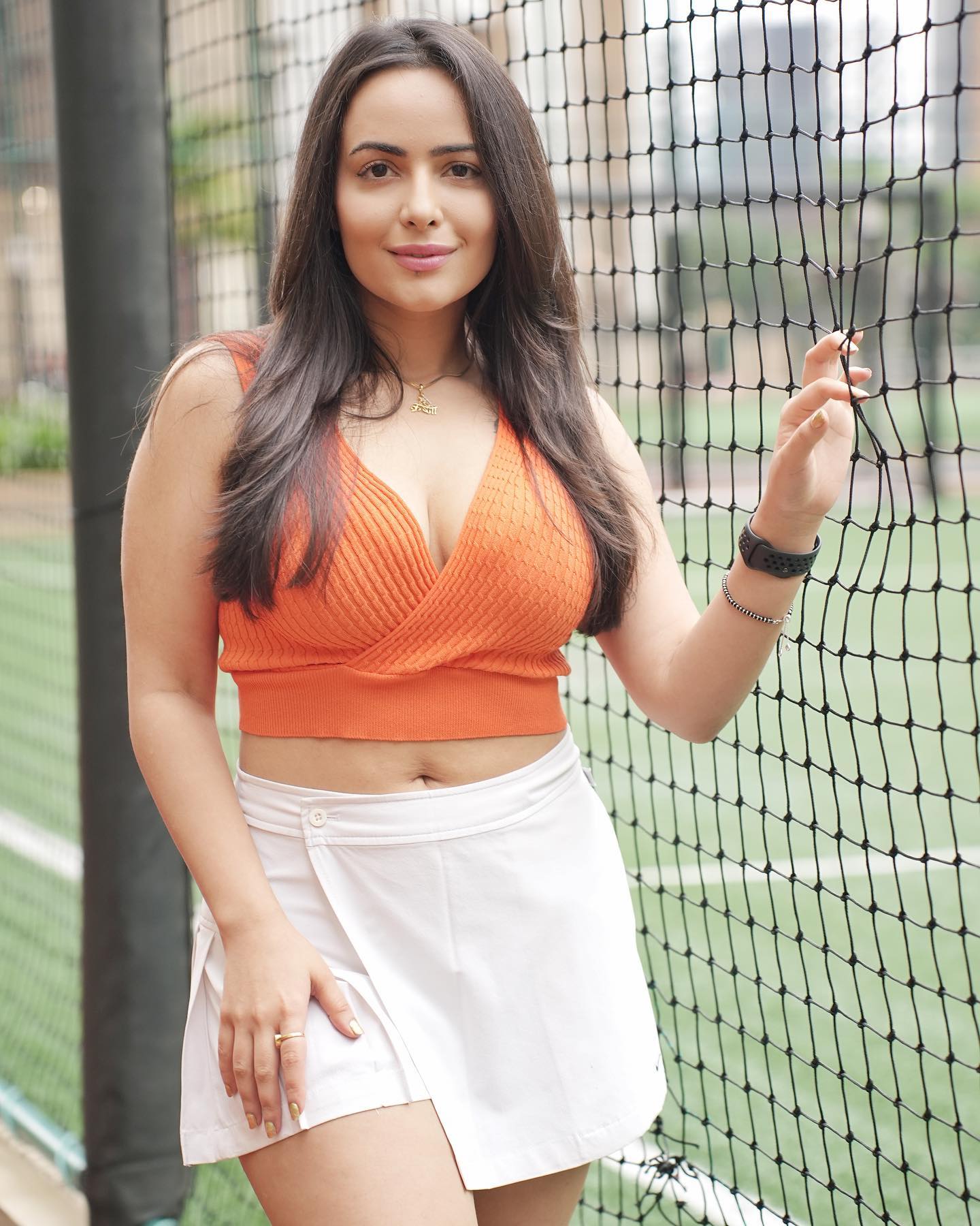 Aanchal Munjal in White Mini Tennis skirt and orange Bralette